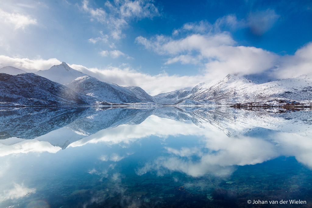 the perfect reflection of blue sky and white mountains create a infinite world. Lofoten, Norway